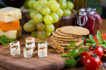 selection of soft cheese with fruits, spices and meat