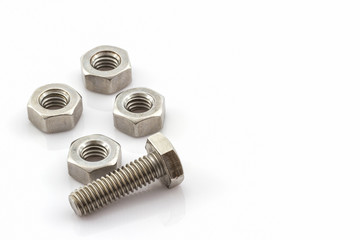 Metal screw and nuts on white background.