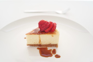 Small slice of cheesecake on a big plate