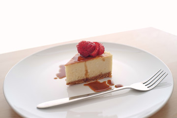 Small slice of cheesecake on a big plate