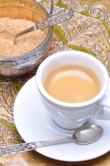 White cup of coffee and silver sugar bowl