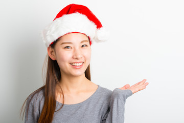 Young asian woman with Christmas hat isolated on white.