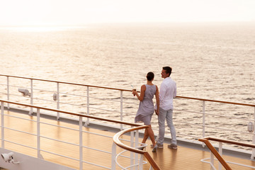couple walking on cruise ship deck - obrazy, fototapety, plakaty