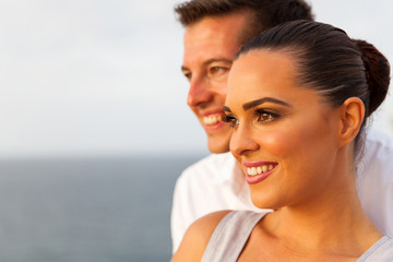 young woman with boyfriend looking away on cruise ship