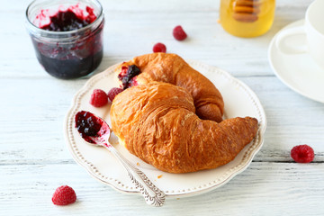 delicious croissant with raspberries and jam