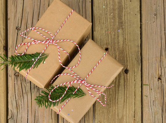 string and brown paper parcels with conifer branches