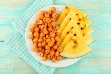 Slices of yellow watermelon and raspberry