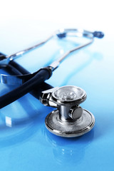 Stethoscope on light blue background