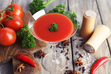 Tomato juice in goblet and fresh vegetables