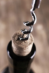 Bottle opener close-up, on wooden background