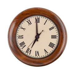 Vintage clockface showing seven o'clock in wooden frame