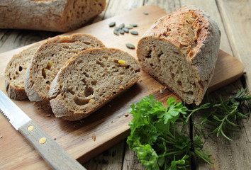 Bread cutting on slices on wooden board