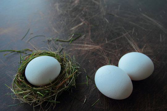 Egg in a nest. Eco eggs on wooden background