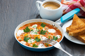 fried quail eggs in tomato sauce and toasts
