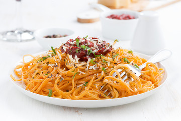 pasta with tomato sauce and parmesan cheese on plate, close-up