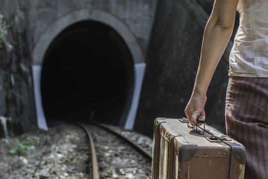 Woman And Vintage Suitcase On Railway Road