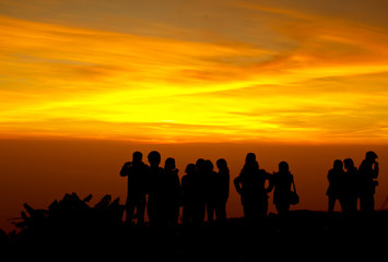 Fototapeta na wymiar group of people on top of a mountain waiting for take photo with