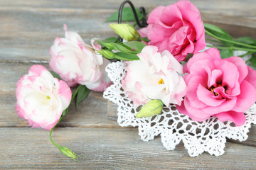 Beautiful eustoma flowers on wooden background