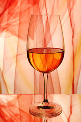 Red wine glass of wine on bright background