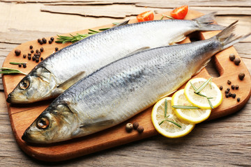 Fresh raw fish and food ingredients on table