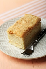 Napoleon cake on plate on table close-up