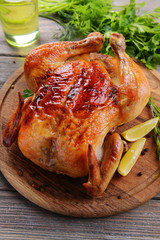 Delicious baked chicken on table close-up