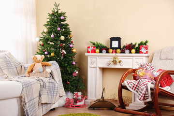Beautiful Christmas interior with decorative fireplace and fir