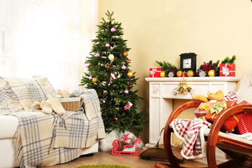 Beautiful Christmas interior with decorative fireplace and fir