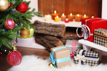 Fireplace with beautiful Christmas decorations and gifts in