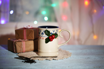 Christmas composition with cup of hot drink, on wooden table