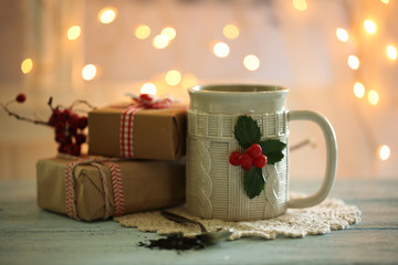 Christmas composition with cup of hot drink, on wooden table