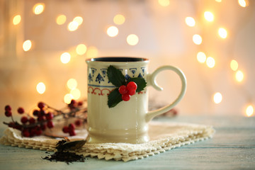Christmas composition with cup of hot drink, on wooden table