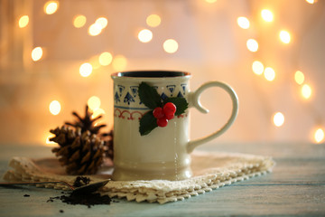 Christmas composition with cup of hot drink, on wooden table