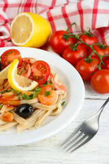Tasty pasta with shrimps, black olives and tomato sauce