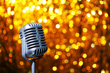 Fototapeta na wymiar Silver microphone on orange background