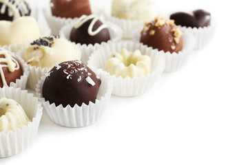 Delicious chocolate candies on white background