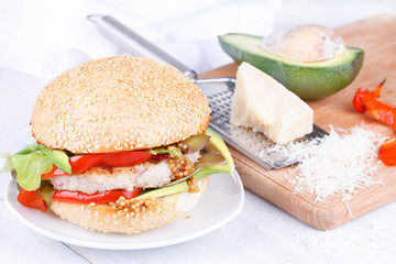 Burger with turkey and avocado on a sesame seed bun