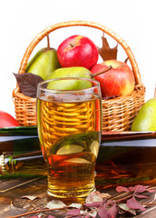 Glass and bottles of cider, fruits basket with apples and pears