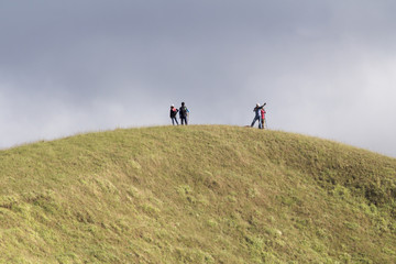 Obraz premium Tourist on the mountain top. Trekking and active life concept