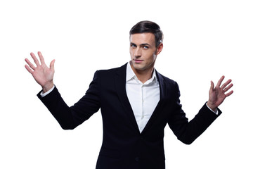 Happy businessman standing with hands on the sides