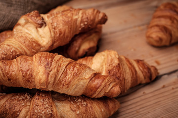 Some croissants on a wooden surface