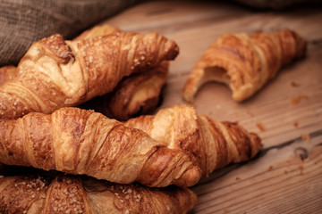 Some croissants on a wooden surface