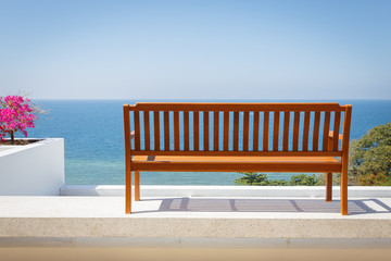 Fototapeta na wymiar Wooden bench stand on the balcony