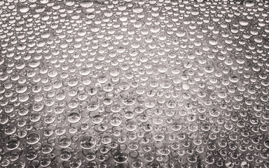 Water drop on glass background.