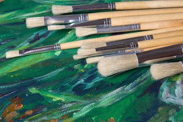 set of paint brushes on oil paints