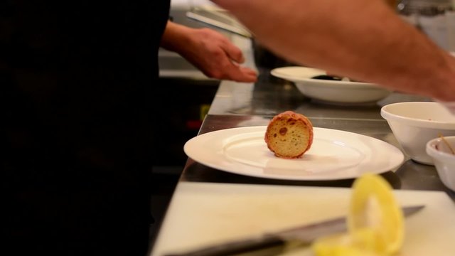 chefs prepares food - steak tartare and see shell