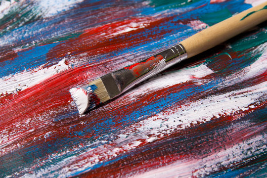 brush on acrylic paint background with blue and red strokes