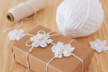 Obraz na płótnie Canvas White crochet snowflakes for Christmas decoration of box gift