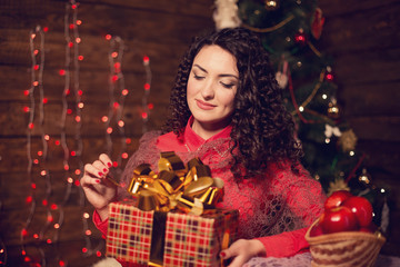 Fototapeta na wymiar Cute woman with candle next to christmas tree