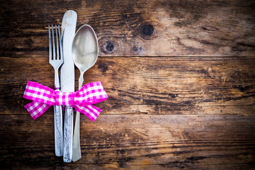 Old knife, spoon and fork decoratively presented.